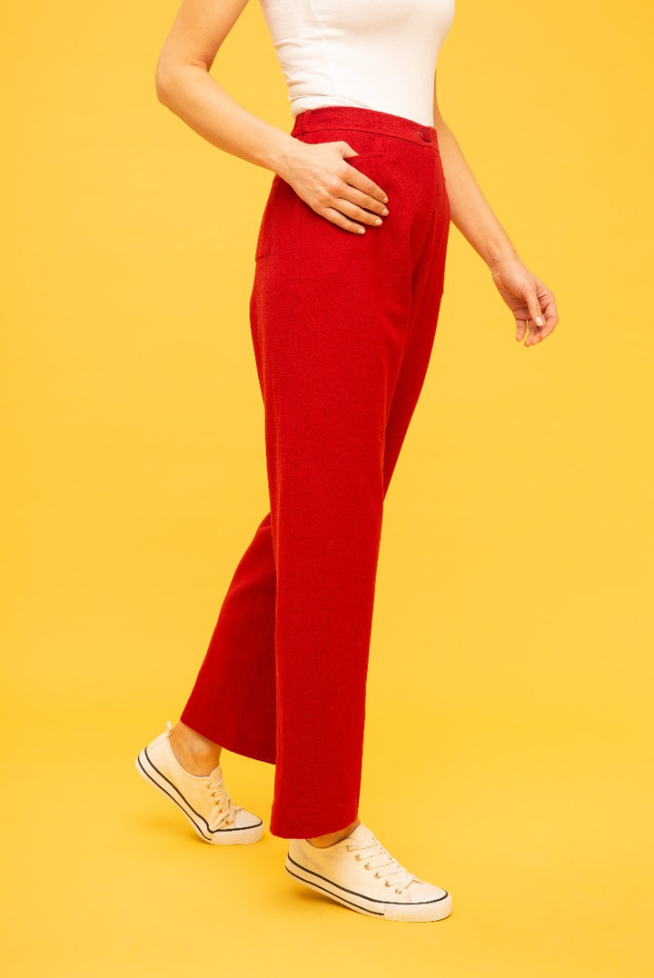 Lily Ella Collection vibrant red tailored trousers for women, stylish casual wear with side pockets, paired with white top and classic sneakers on a yellow background.