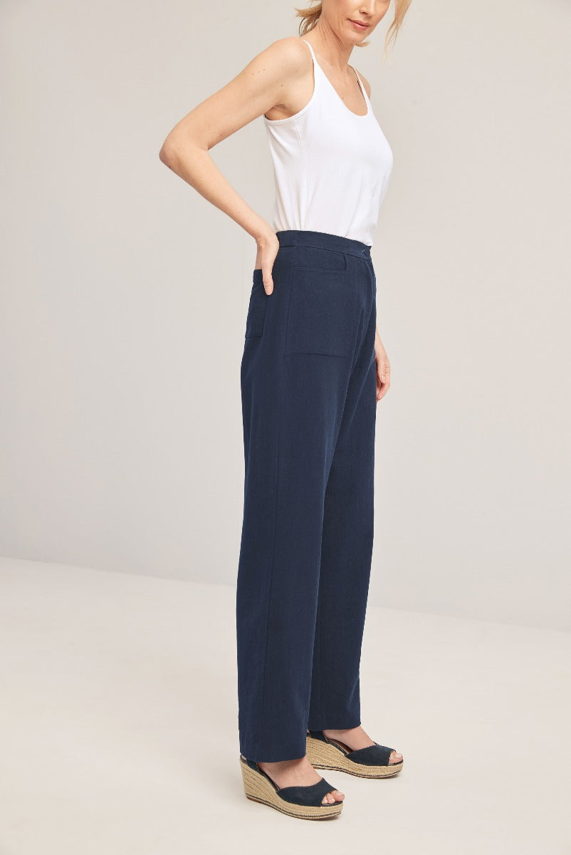 Lily Ella Collection navy blue wide-leg trousers for women, styled with white sleeveless top and wedge sandals, sophisticated casualwear, front pocket detail.