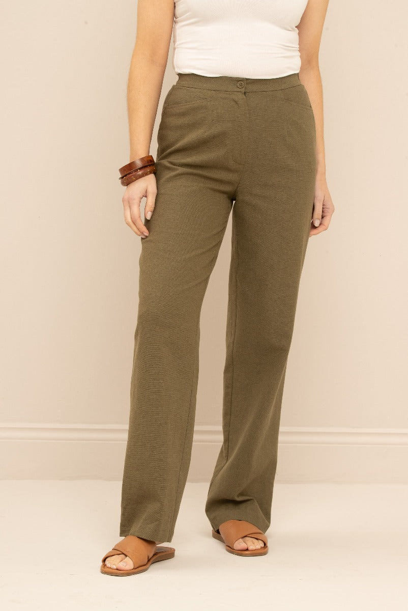 Lily Ella Collection olive green textured trousers for women, casual straight-leg fit, styled with white top and brown accessories.
