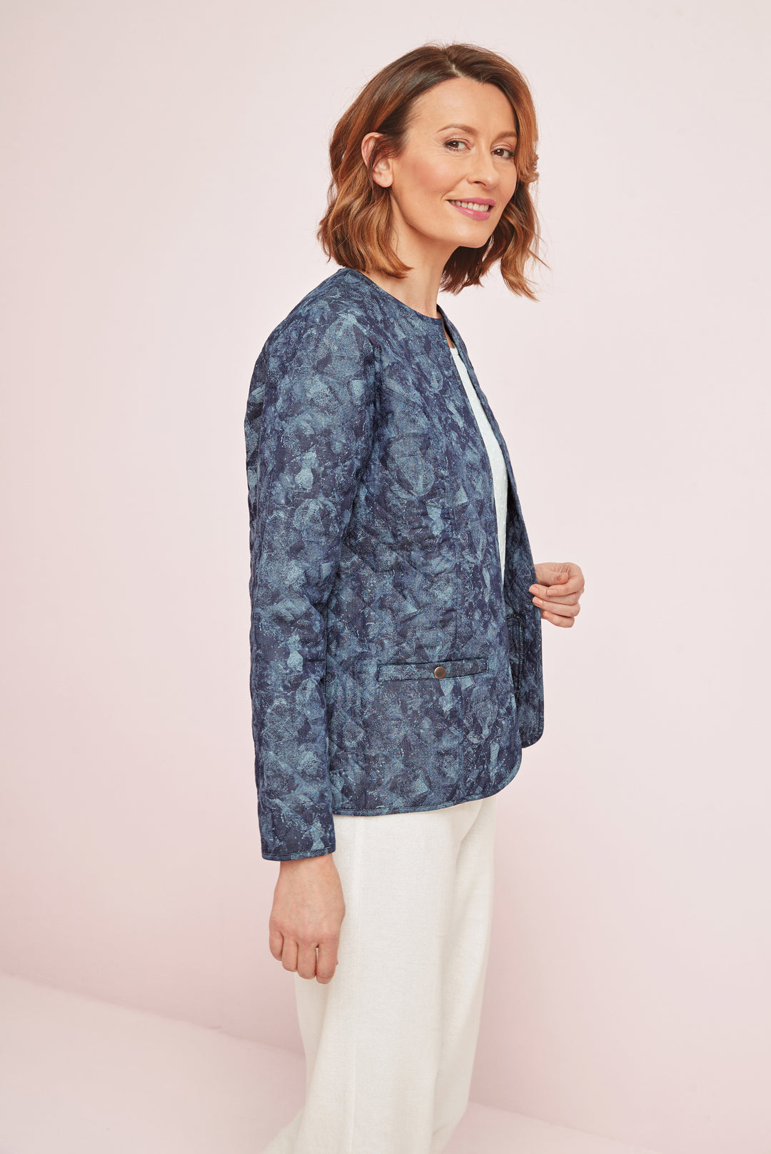 Lily Ella Collection stylish navy floral patterned blazer for women paired with elegant white trousers, trendy and sophisticated office wear.