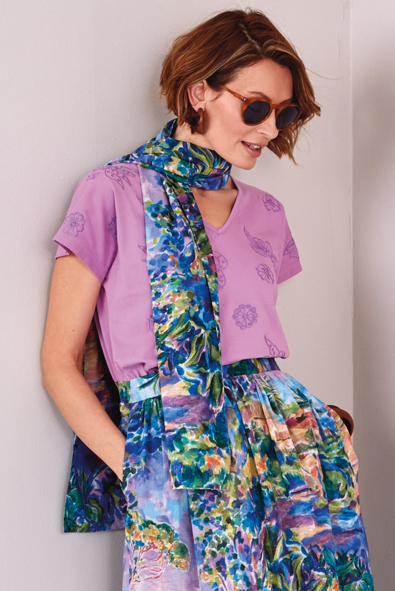 Lily Ella Collection women's fashion, model wearing lilac floral t-shirt with vibrant blue and green floral printed scarf and skirt, stylish summer outfit, trendy women's clothing.