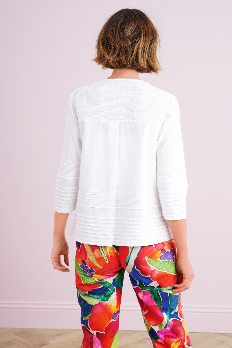 Lily Ella Collection stylish white textured jacket paired with colorful floral print trousers for women, elegant casual wear, back view fashion outfit, contemporary female clothing.
