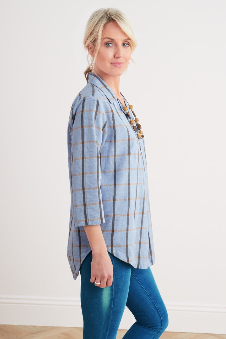 Lily Ella Collection stylish light blue and beige checked tunic top, casual chic women's fashion, paired with denim jeans and layered necklace accessories.