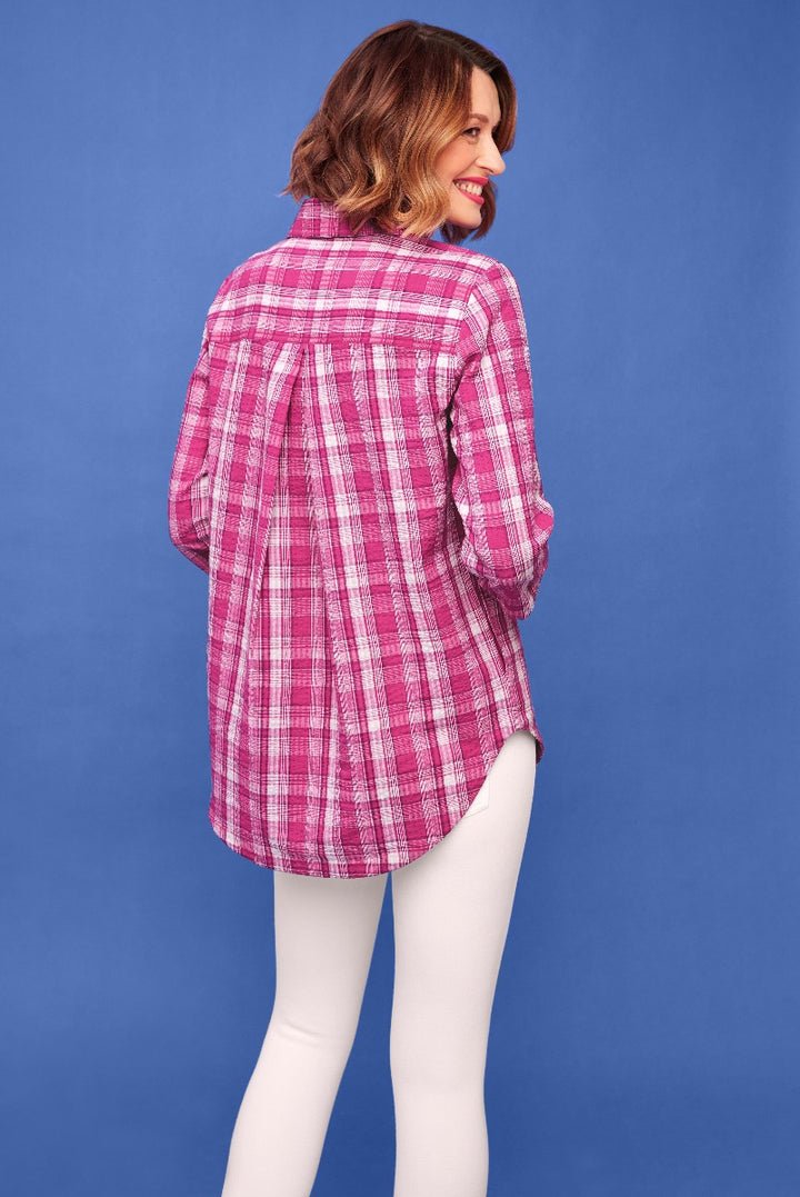 Lily Ella Collection pink checkered shirt with rolled-up sleeves, styled with white leggings, fashion model showcasing contemporary women's casual wear against a blue background