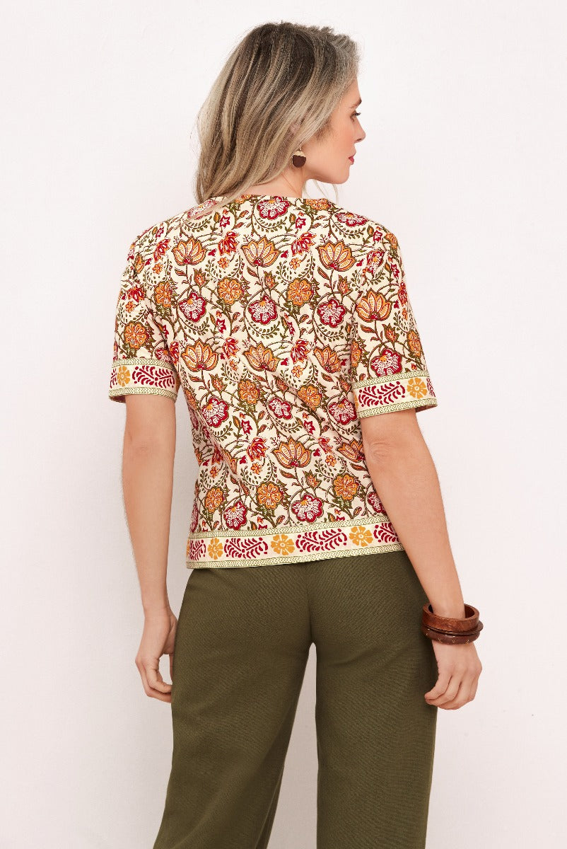Lily Ella Collection patterned blouse in warm tones, featuring bohemian-style print, paired with olive green trousers for a sophisticated and casual look.