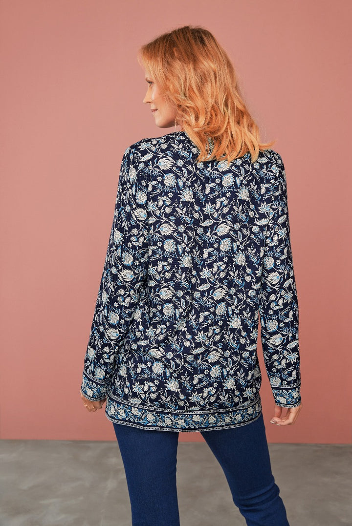 Lily Ella Collection navy blue floral patterned blouse and slim-fit jeans, stylish casual wear for women, modern fashion clothing, back view of model showcasing design details.
