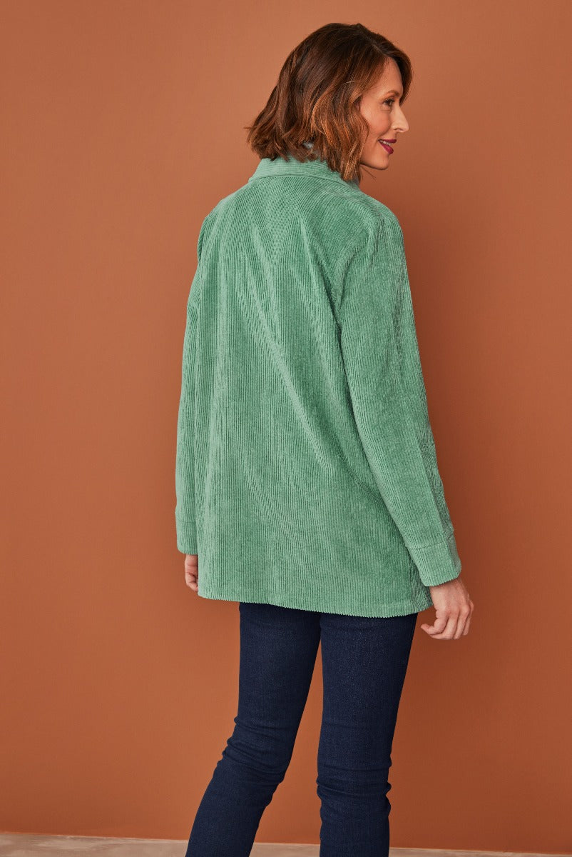 Lily Ella Collection green corduroy shirt, women's casual style, rear view on model with dark blue jeans, fashionable autumn clothing