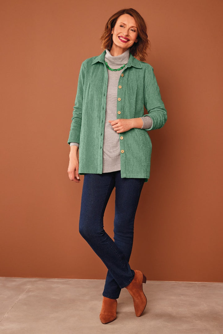 Lily Ella Collection women's fashion, model wearing sage green corduroy jacket, grey top, dark blue skinny jeans, and tan ankle boots, stylish casual outfit.