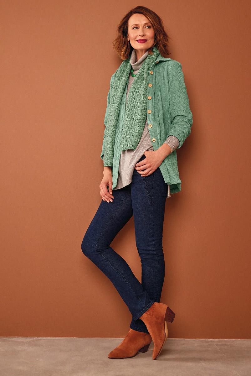 Lily Ella Collection green cable knit cardigan with gold button details paired with slim-fit denim jeans and brown ankle boots for a casual chic look.