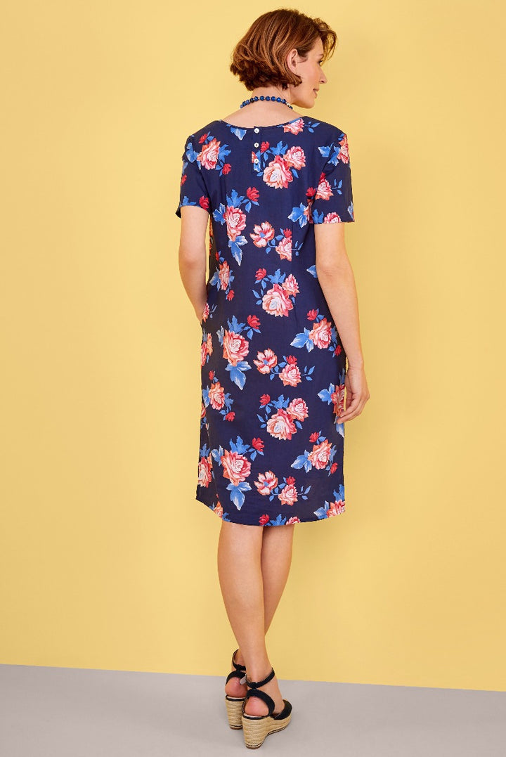 Lily Ella Collection navy blue floral dress, short-sleeve knee-length A-line style, women's fashion, rear view with model showcasing floral pattern and design details.