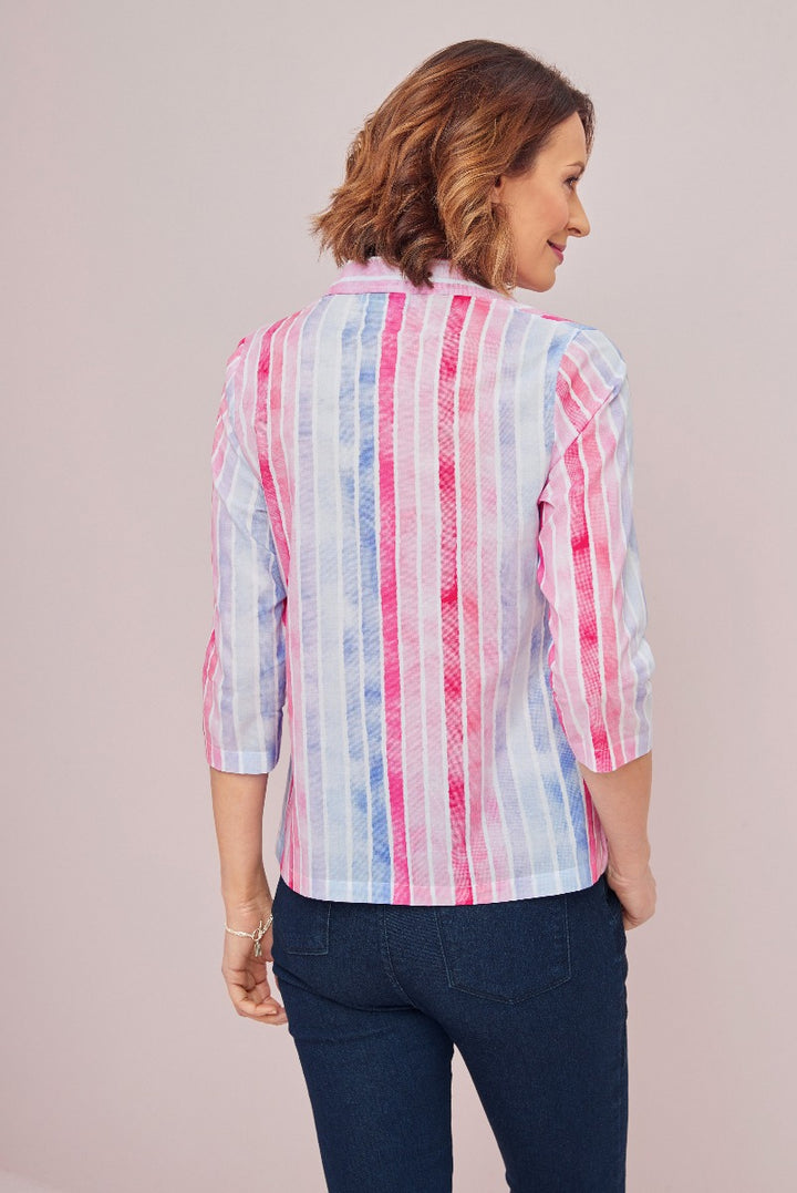 Lily Ella Collection women's casual striped shirt in pink and blue, rolled-up sleeve detail, styled with dark denim jeans, rear view of fashion outfit.