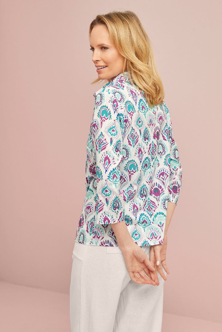 Lily Ella Collection stylish paisley pattern blouse in teal and pink, elegant casual wear for women, matched with white trousers
