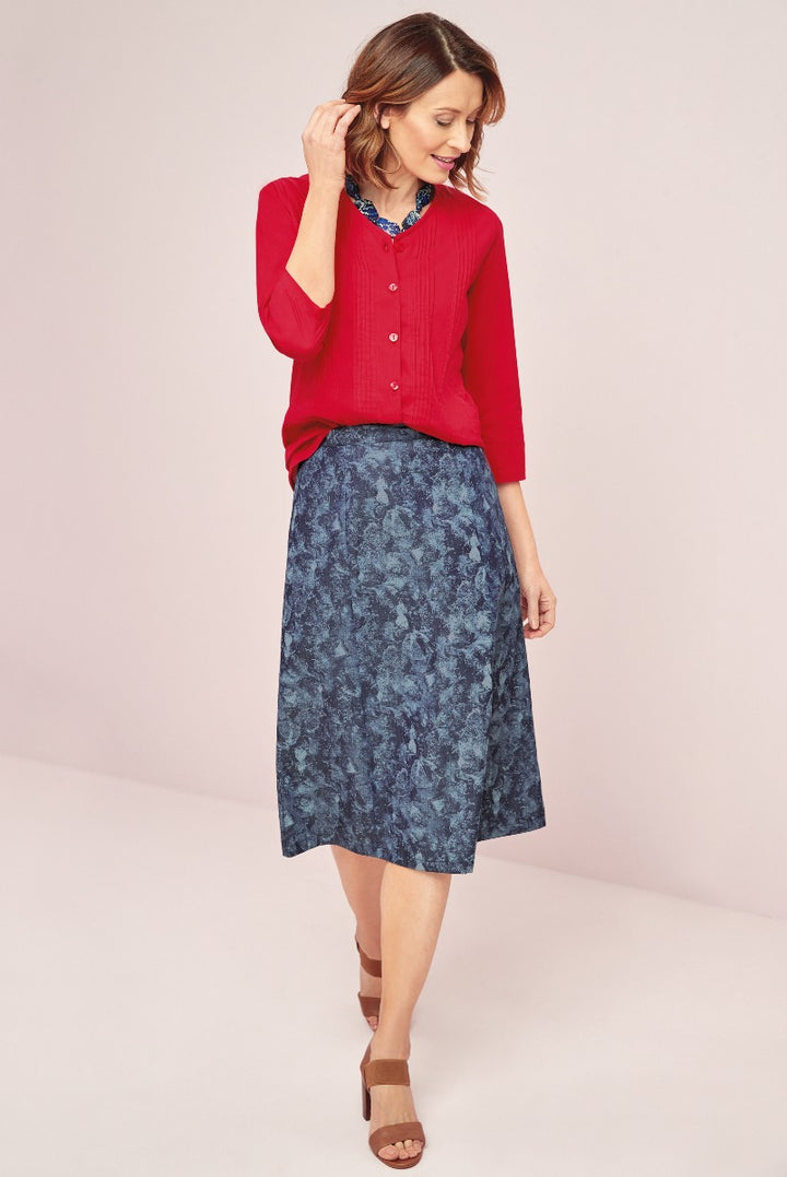 Lily Ella Collection elegant red cardigan with A-line blue floral skirt and chic brown sandals on model for spring fashion.
