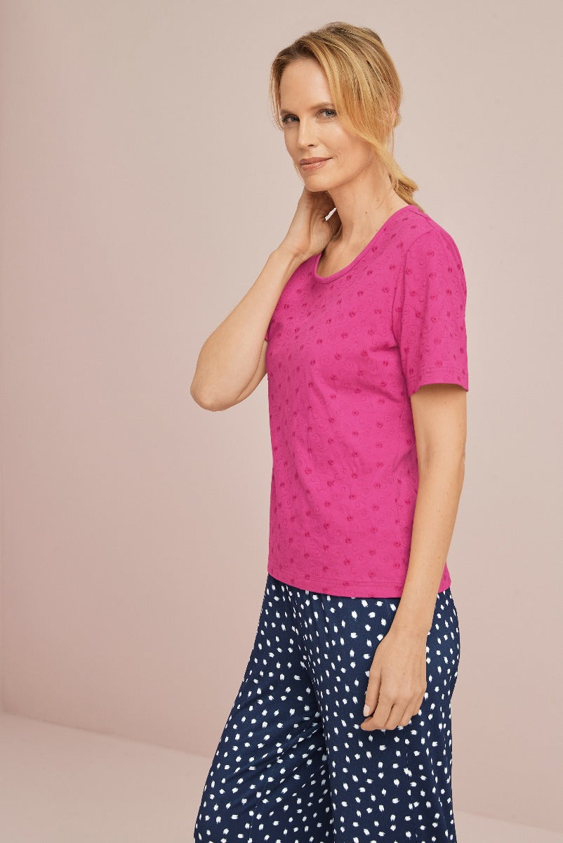 Lily Ella Collection pink embroidered t-shirt with casual style paired with navy polka-dot trousers for sophisticated everyday women's fashion.