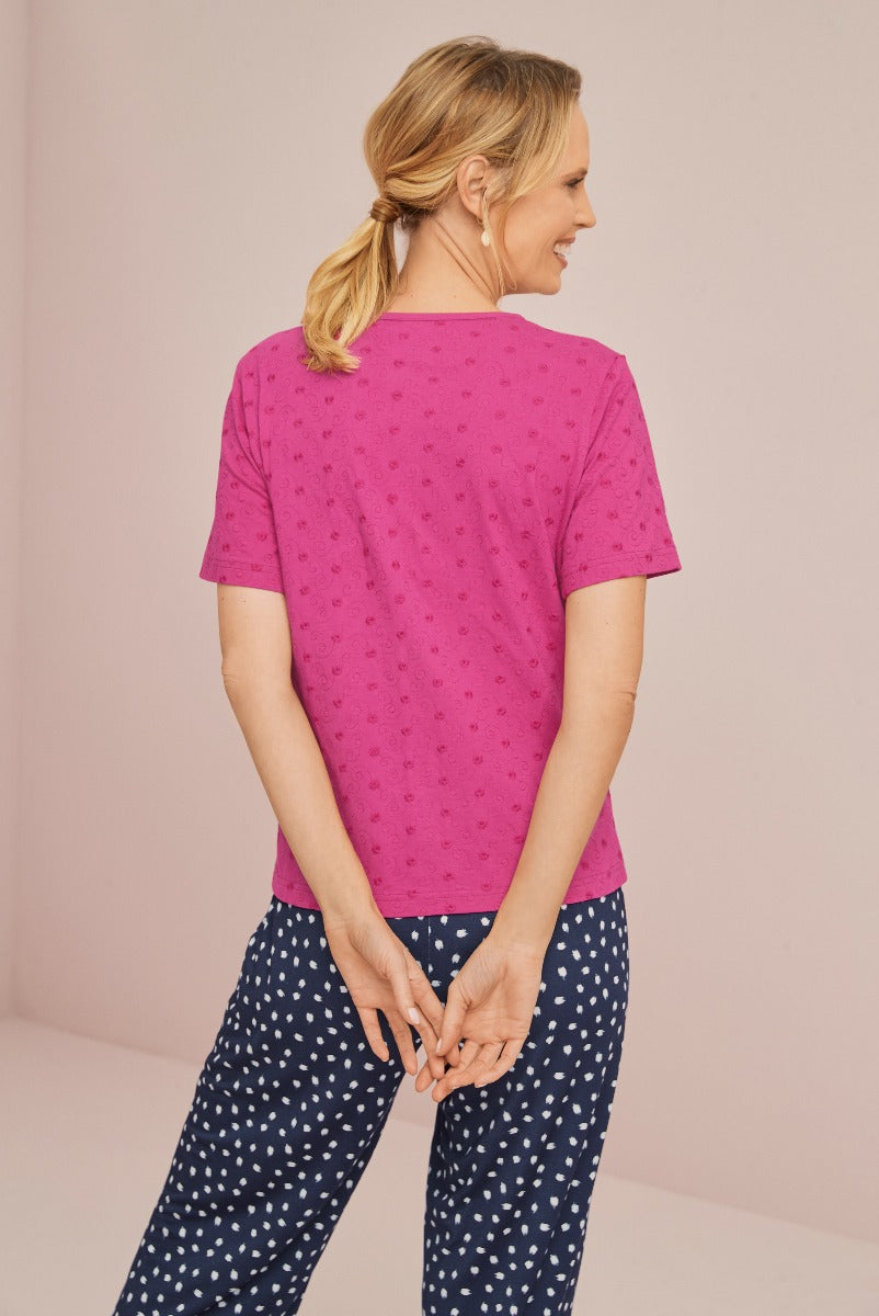 Lily Ella Collection fuchsia pink textured top and patterned navy trousers, comfortable chic women's casual wear, stylish back view.