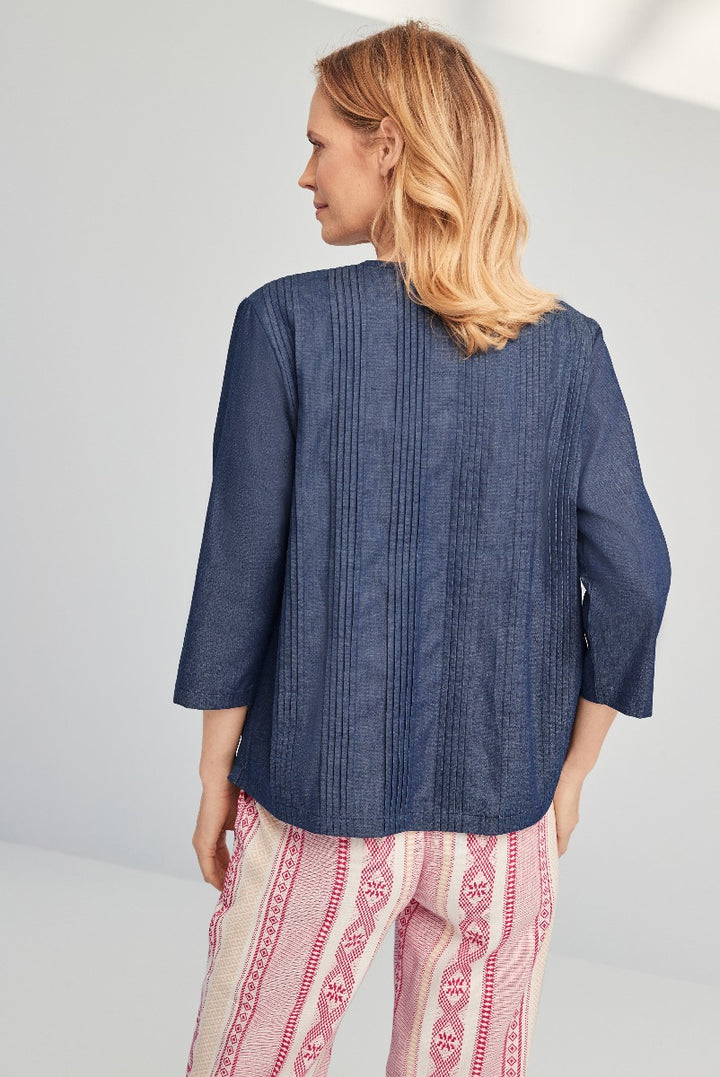 Lily Ella Collection women's denim blue pin-tuck blouse with three-quarter sleeves paired with patterned pink trousers, stylish casual wear, rear view