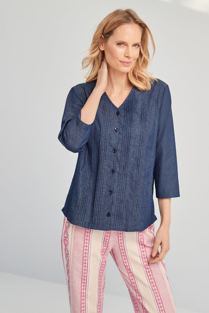 Lily Ella Collection stylish navy textured blouse with button-down front paired with patterned pink and white trousers for a chic casual look