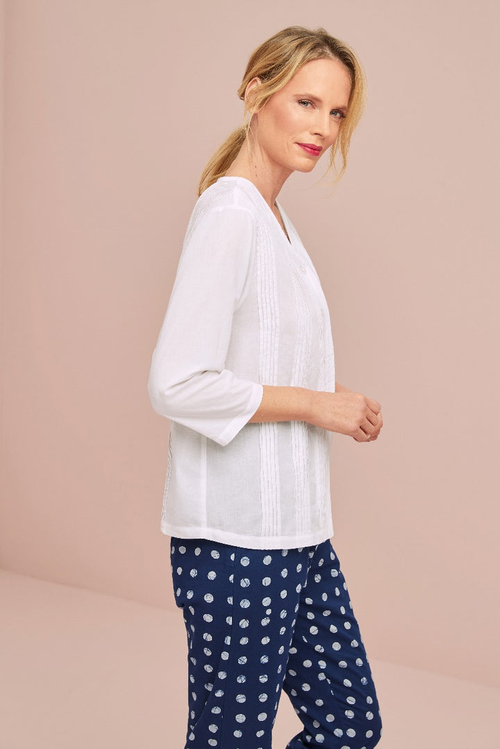 Lily Ella Collection elegant white blouse with textured front detail paired with stylish navy patterned trousers, featuring a modern casual look perfect for everyday fashion.