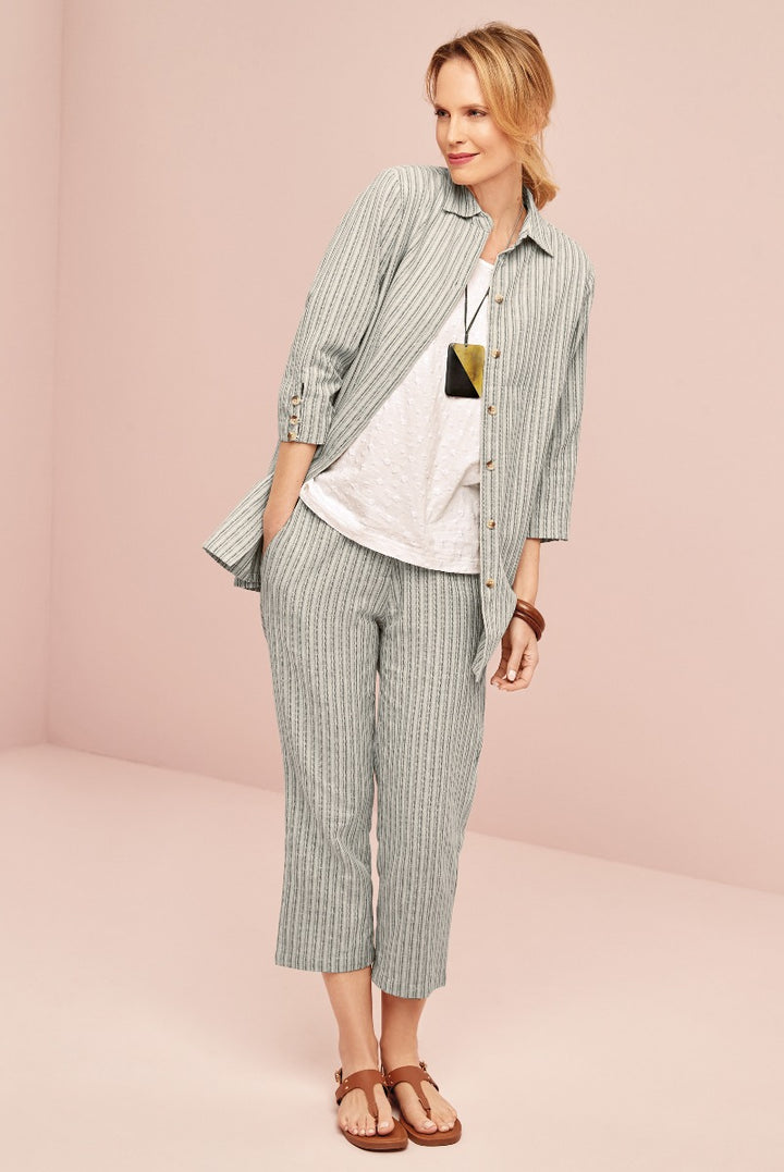 Lily Ella Collection light green striped jacket and matching cropped trousers, casual women's wear, fashionable spring outfit with white top and brown sandals, stylish mature female model posing in elegant clothing.