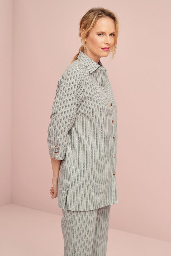 Lily Ella Collection striped grey shirt and matching trousers, elegant women's casual wear, button-up top, model showcasing contemporary fashion against pink backdrop
