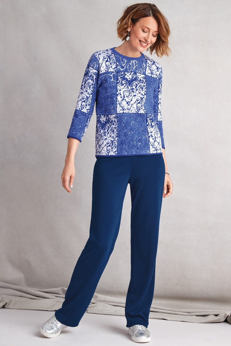Lily Ella Collection featured outfit with a blue and white patterned top and navy trousers, stylish women's apparel for a casual yet elegant look.