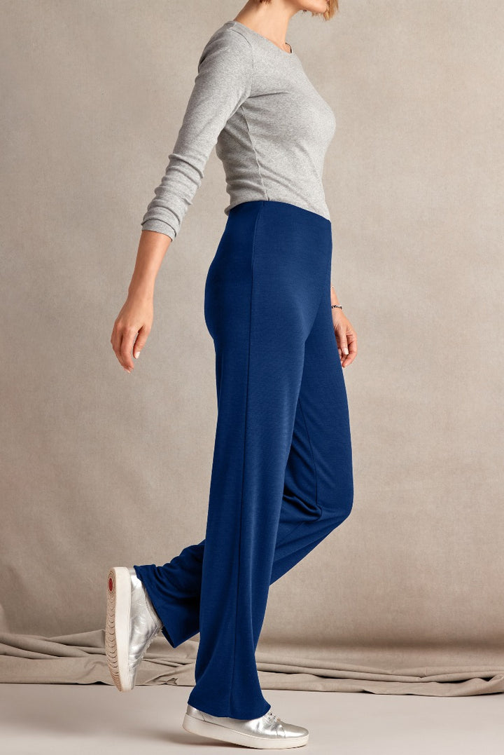 Lily Ella Collection elegant blue palazzo pants for women, comfortable chic wide-leg trousers, paired with grey top and silver sneakers, perfect for casual or work wear.
