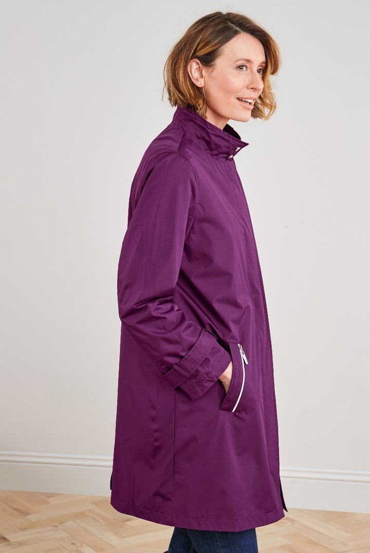 Lily Ella Collection purple waterproof raincoat, stylish women's outerwear, side view of model showcasing fit and design elements.