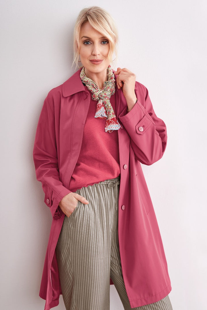 Lily Ella Collection elegant woman in fuchsia trench coat with patterned scarf and pink sweater, stylish outerwear for women, trendy fashion.