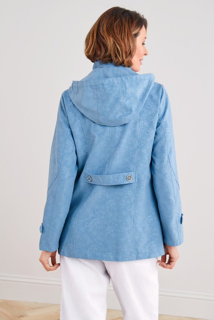 Lily Ella Collection women's blue patterned jacket rear view with high-collar design and button detail, paired with white trousers.
