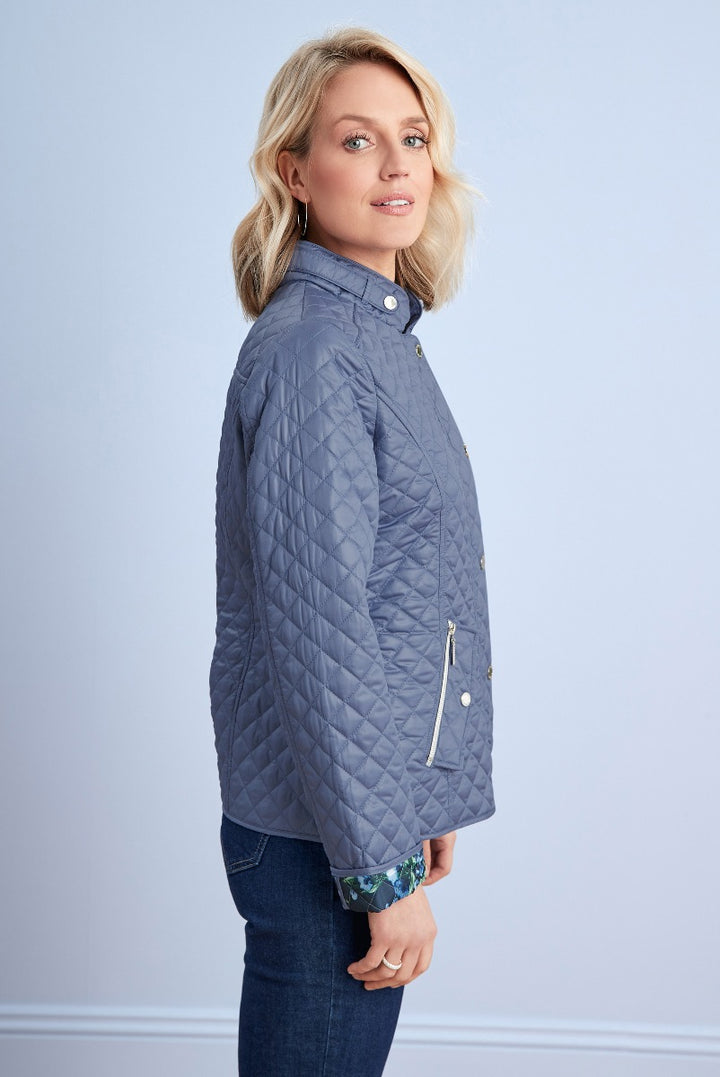 Lily Ella Collection blue quilted jacket, women's stylish lightweight outerwear, side view with floral cuff detail