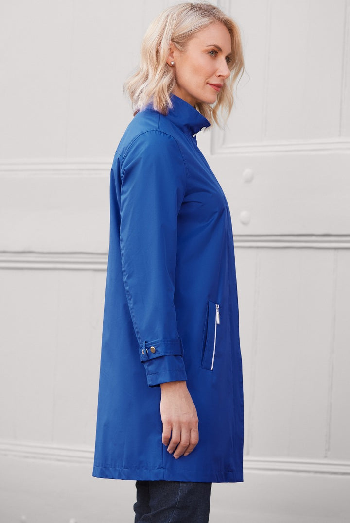 Lily Ella Collection elegant royal blue trench coat, side view of a stylish woman showcasing modern outerwear with silver zipper details, chic casual fashion for women.