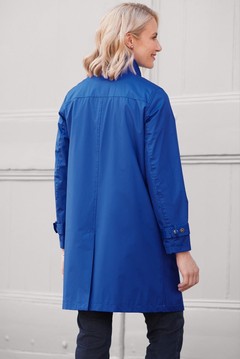 Lily Ella Collection elegant royal blue raincoat for women, stylish long-sleeve waterproof jacket, rear view on model, contemporary outerwear fashion