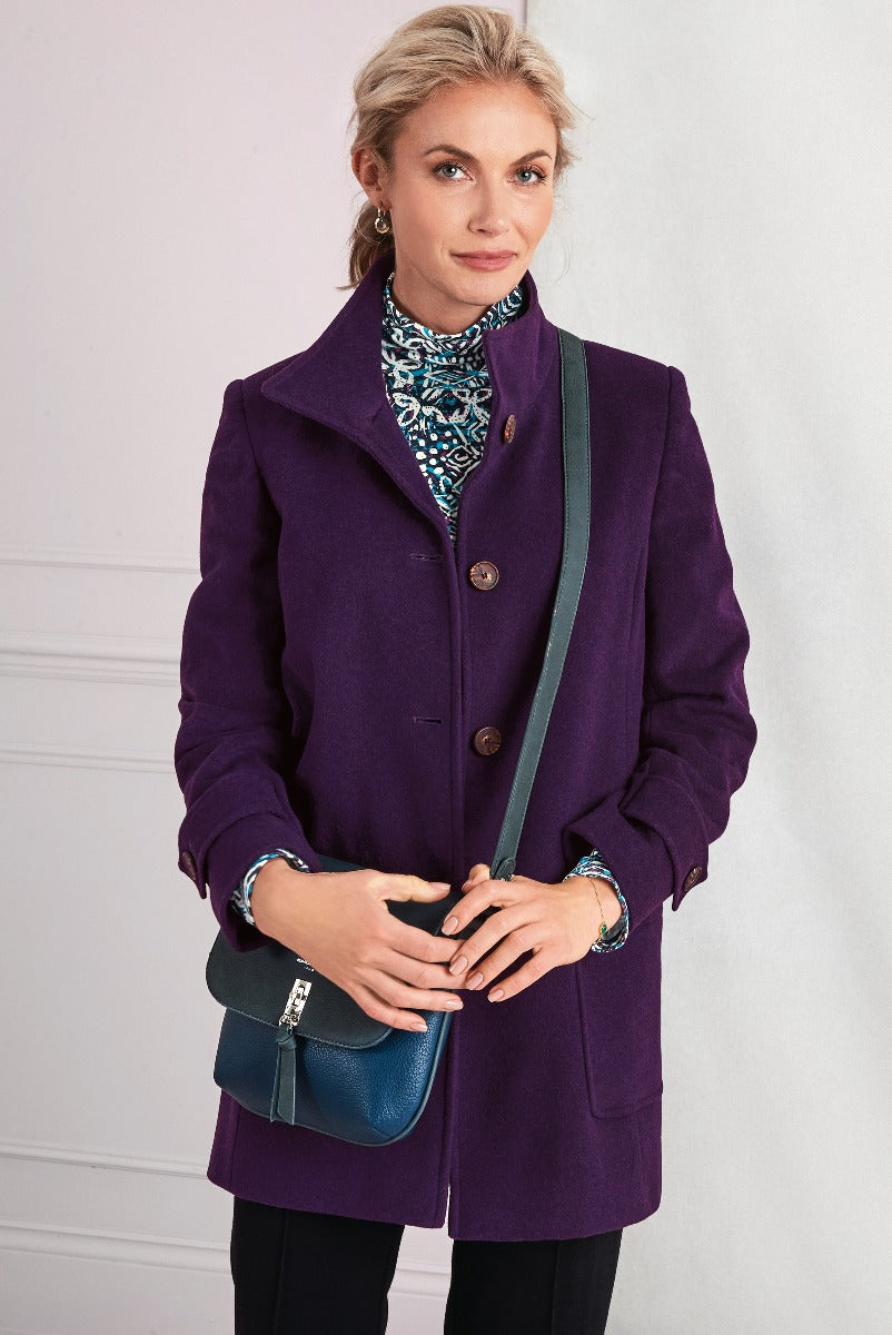 Lily Ella Collection elegant purple wool coat with button closure, stylish teal patterned scarf, accessorized with a chic crossbody bag, fashion-forward women's outerwear.