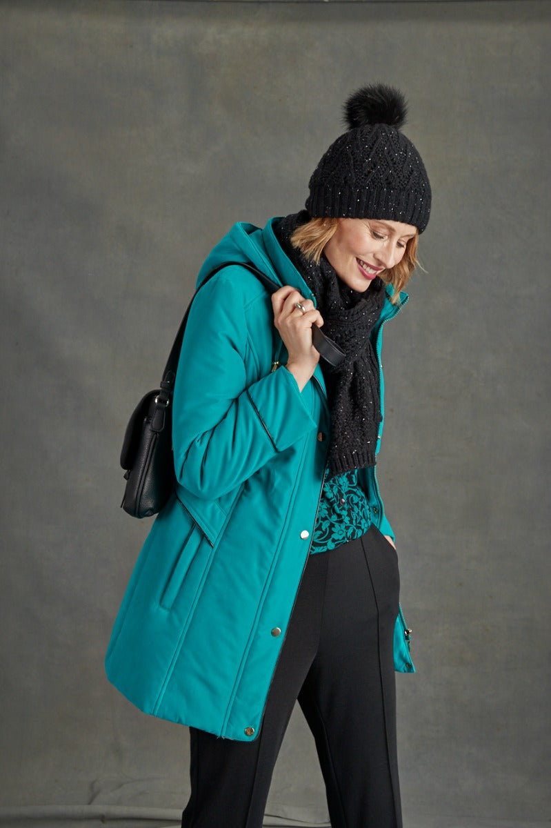 Lily Ella Collection teal winter coat styled with black pompom beanie and scarf, showcasing casual chic women's outerwear.
