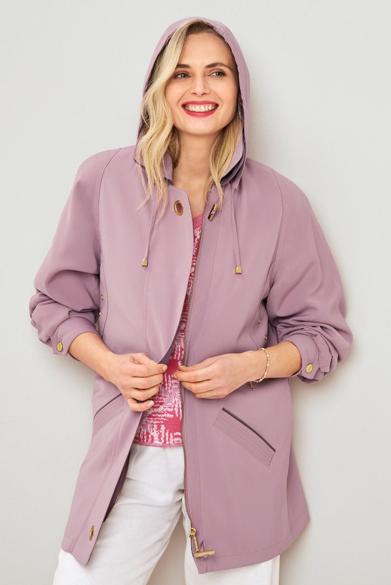 Lily Ella Collection stylish mauve hooded jacket, casual-chic women's outerwear, paired with white pants and a patterned pink top.