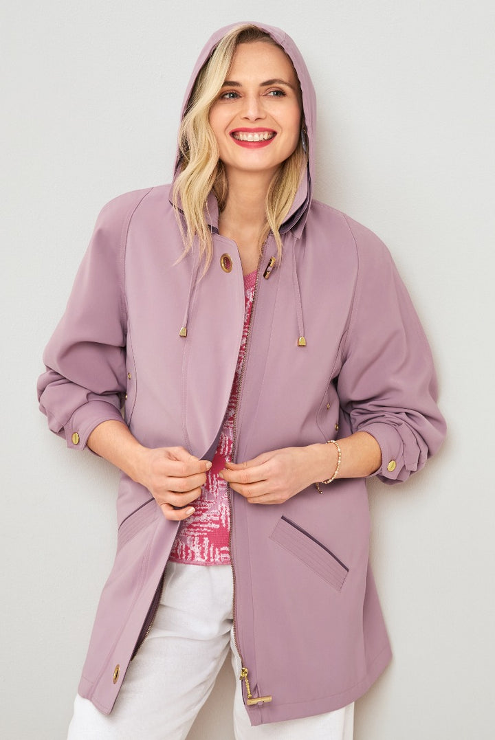 Lily Ella Collection mauve zip-up jacket with hood and gold-tone hardware paired with a shimmering pink top and white trousers, showcasing comfortable yet stylish spring outerwear for women.