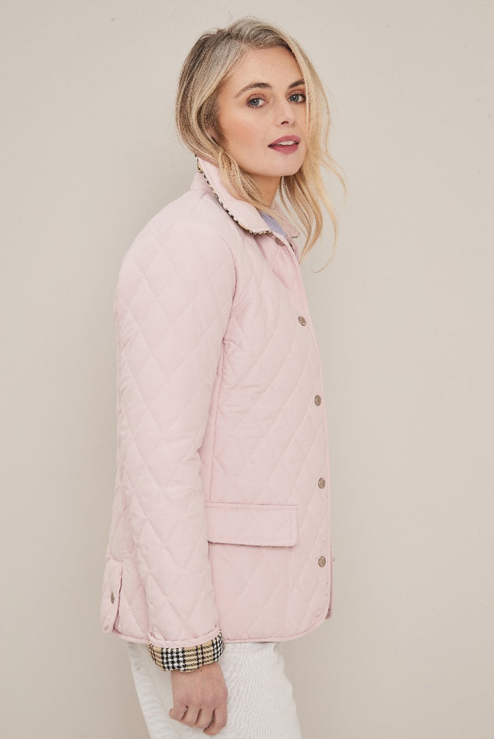 Lily Ella Collection pink quilted jacket for women, elegant light pastel color, diamond stitching detail, casual and chic style with button-down front and patch pocket, versatile outerwear for spring season.