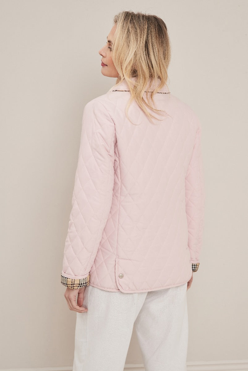 Lily Ella Collection pink quilted jacket with plaid cuff details, rear view of stylish women's outerwear, elegant pastel-toned spring fashion.