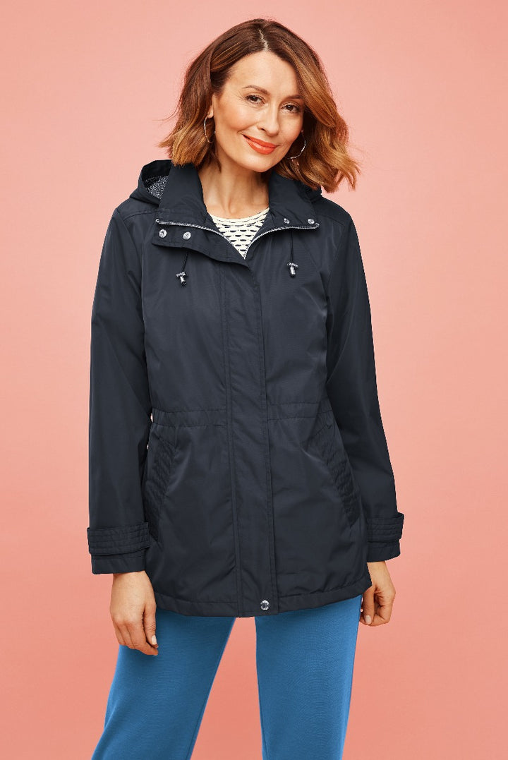 Lily Ella Collection women's navy blue parka jacket with hood, styled with striped top and blue trousers, fashionable autumn outerwear for ladies, casual and comfortable look.