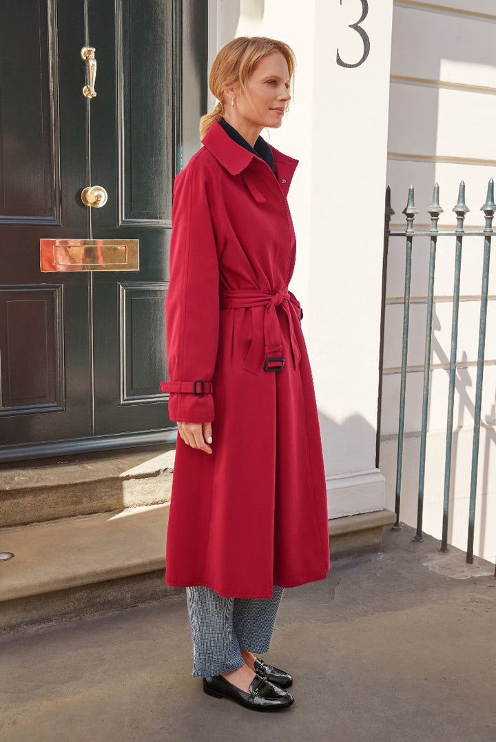 Lily Ella Collection elegant red trench coat with belt, styled with houndstooth trousers and black loafers, sophisticated women's outerwear fashion.