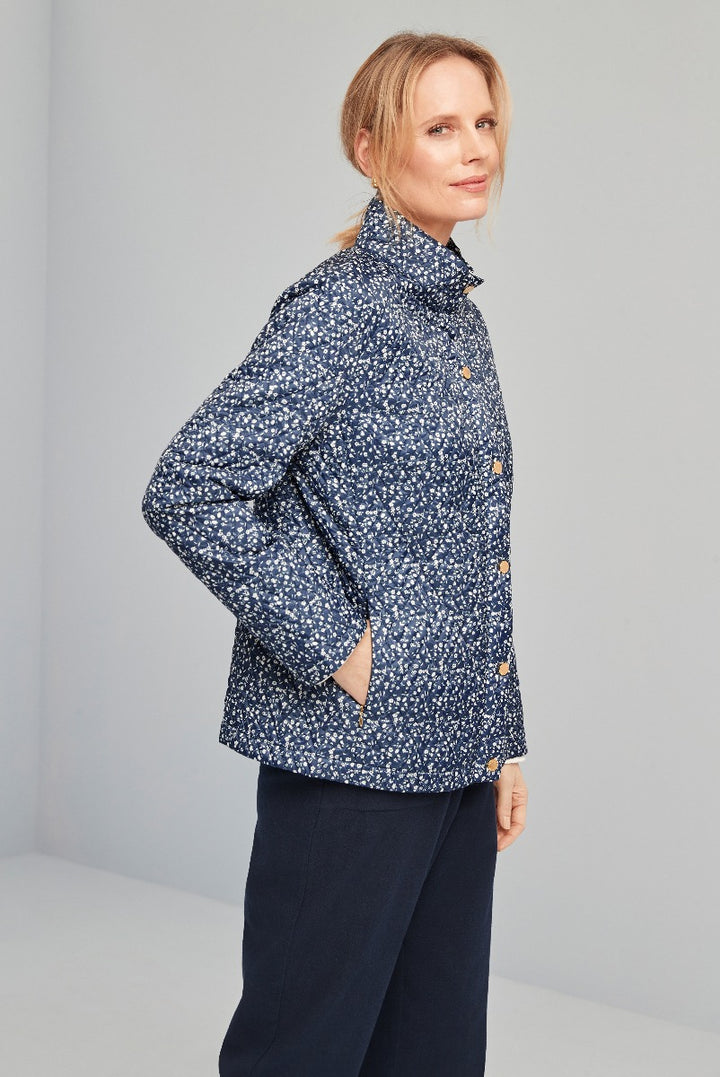 Lily Ella Collection navy blue floral jacket with unique button details on a female model, comfortable chic outerwear for women