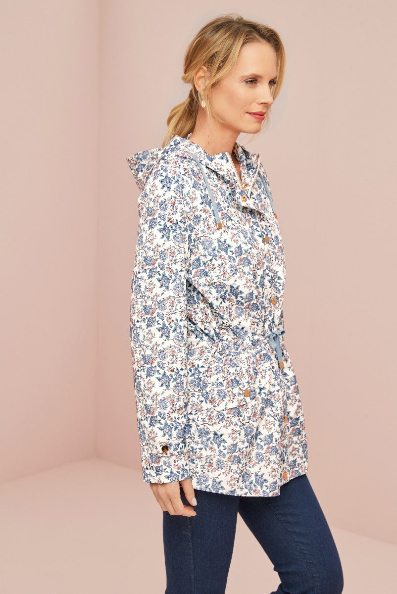 Lily Ella Collection women's blue floral patterned blouse, stylish and elegant design, paired with dark jeans for a casual chic look.
