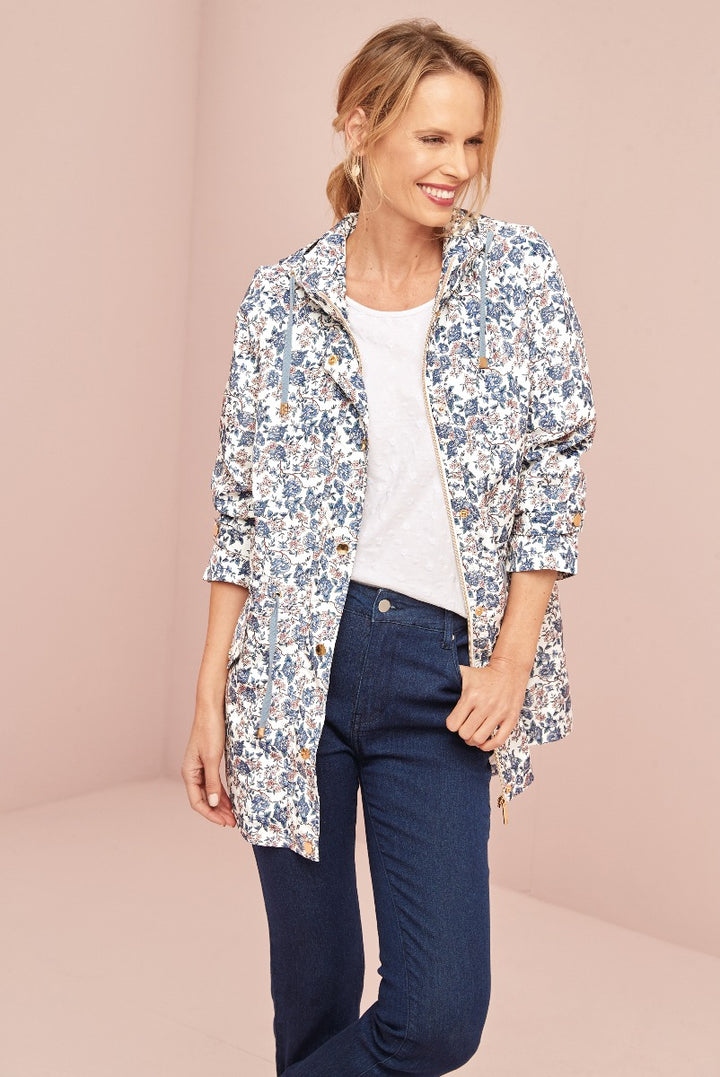 Lily Ella Collection floral jacket in blue and white, stylish women's casual wear, model showcasing latest spring season outerwear design with denim jeans.