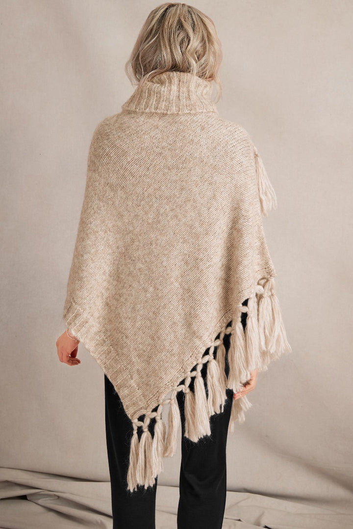 Lily Ella Collection beige tassel poncho, women's high-neck knitwear with fringe detailing, casual yet sophisticated winter fashion accessory.