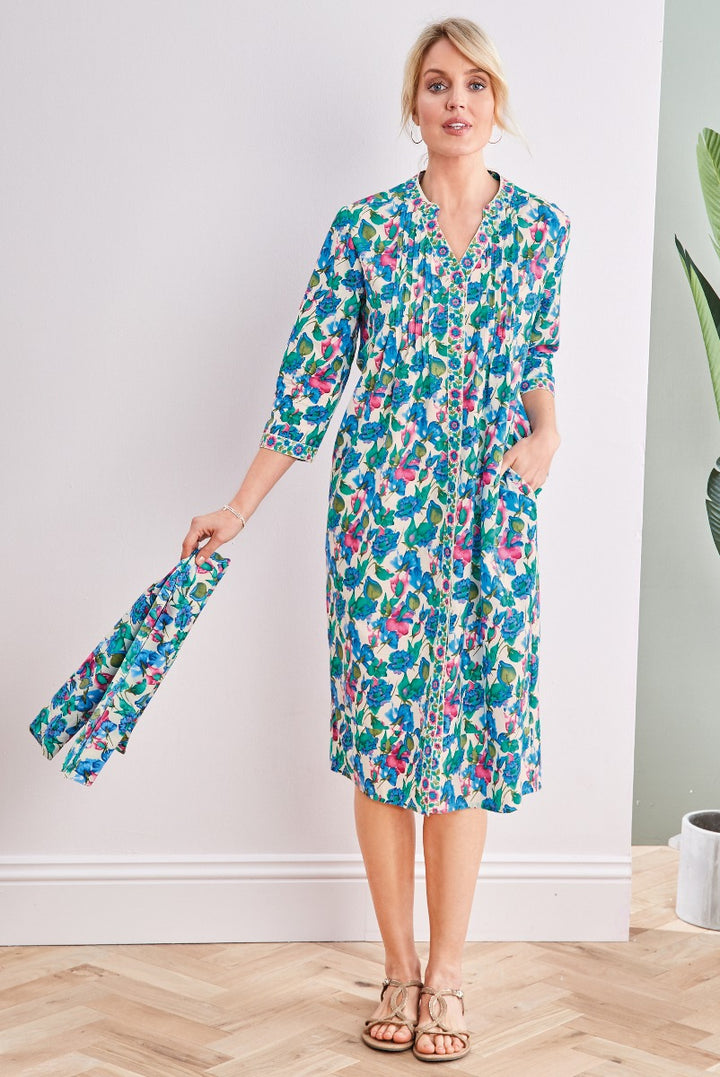 Lily Ella Collection vibrant blue and pink floral print midi shirt dress with three-quarter sleeves and matching clutch on elegant blonde model, stylish women's spring-summer fashion outfit.