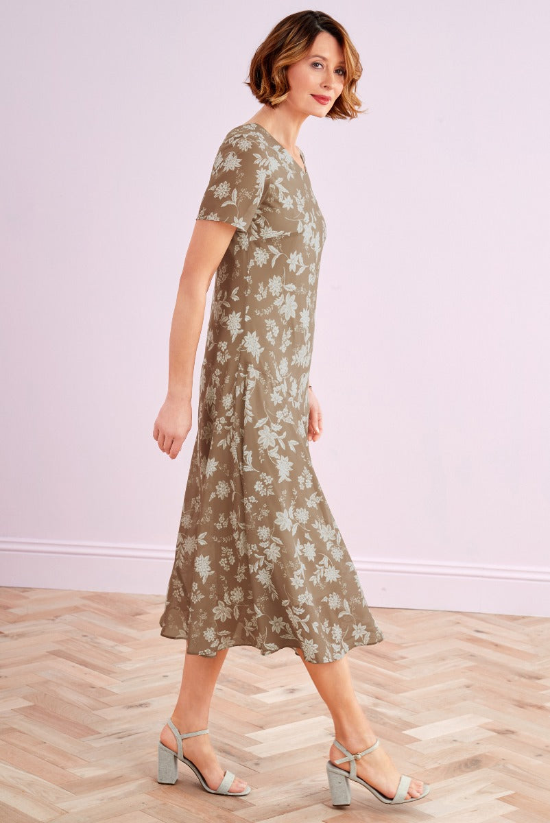 Lily Ella Collection olive floral wrap dress with short sleeves, mid-length cut, and stylish strappy heels for a spring fashion photoshoot.