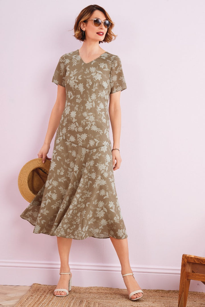 Lily Ella Collection stylish olive green floral midi dress with short sleeves and V neckline, accessorized with straw hat and beige sandals, perfect for casual summer fashion.