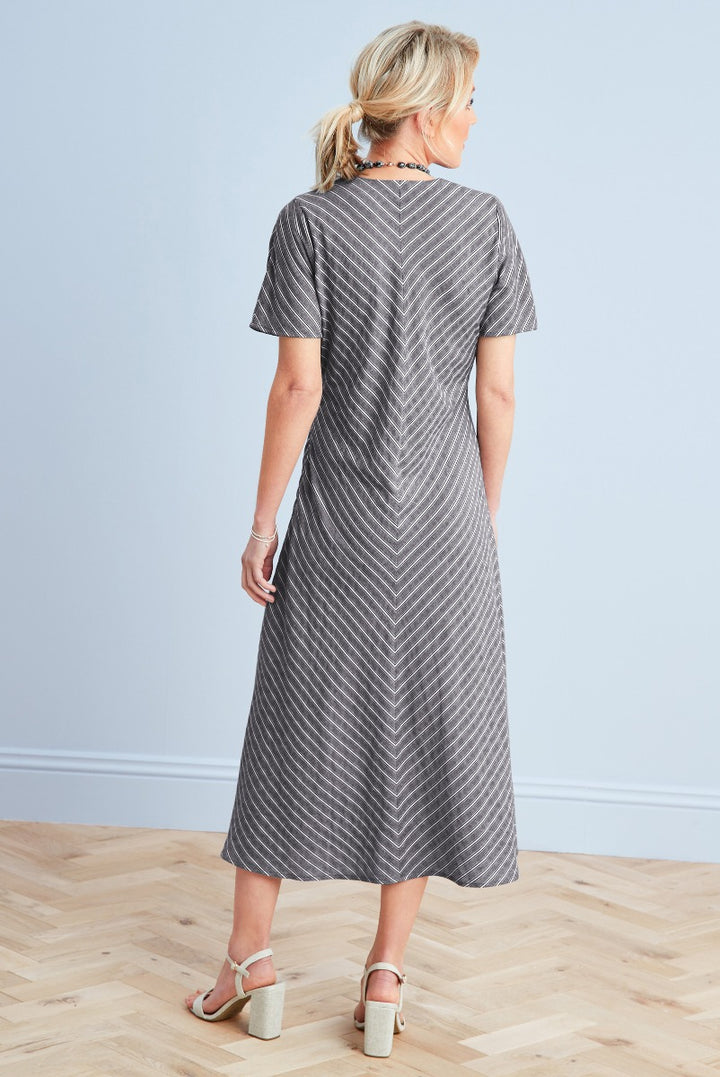 Lily Ella Collection women's mid-length chevron dress in grey, featuring short sleeves and stylish A-line cut, elegant casual wear, model showcased with block heel sandals.