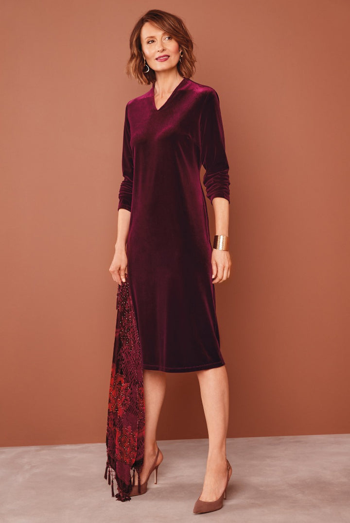Lily Ella Collection elegant burgundy velvet midi dress with V-neck, three-quarter sleeves, and lace accessory, paired with brown heels.