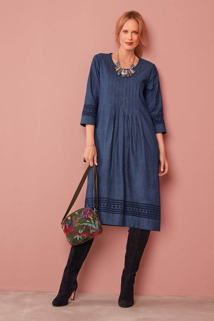 Lily Ella Collection chic denim blue midi dress with intricate embroidery detail paired with suede knee-high boots and floral crossbody bag for a stylish ensemble